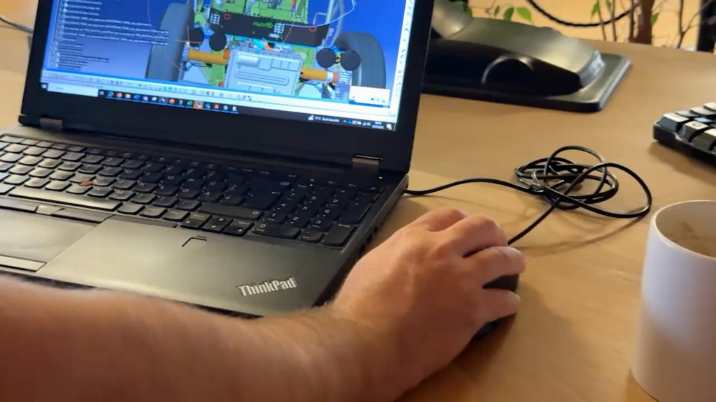 Engineer working on the TWIKE 5 vehicle model in CAD software