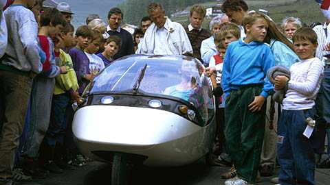 Children and visitors gathered around an early TWIKE 2 during a public presentation